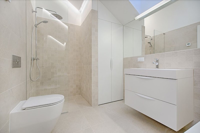 Clean ensuite with frameless shower and wall-hung vanity